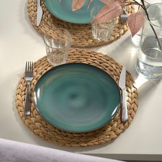 two place settings with green plates and silverware