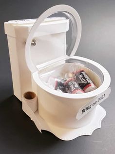 an open toilet with some candy bars in it