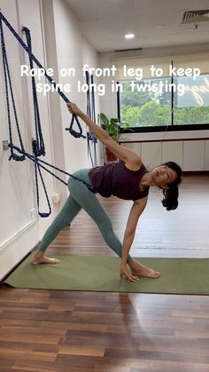 a woman is doing yoga on a mat