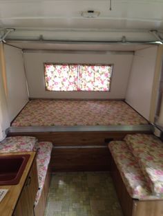 the inside of a camper with two beds in it