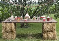 a picnic table with hay bales and drinks on it