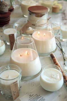 candles are sitting on a table with tags around them