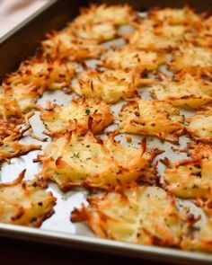 a pan filled with cheesy potatoes on top of a table