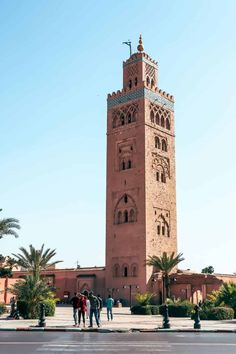 people are standing in front of a tall tower