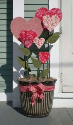 a potted plant with paper hearts in it