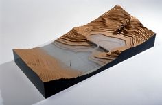 a model of a mountain is shown on a white surface with no people around it