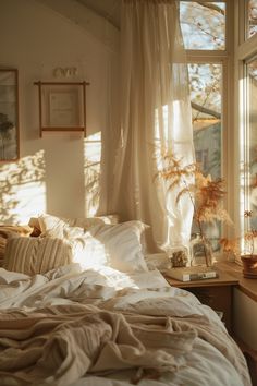 the sun shines through the window onto a bed with white linens and pillows