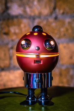 a red robot sitting on top of a table