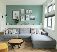 a living room filled with furniture and pictures on the wall above it's couch