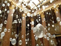 bubbles are floating in the air near columns