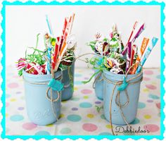 two blue mason jars filled with candy canes