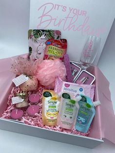 a pink gift box filled with personal care items