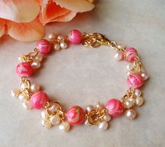 This exquisite bracelet features hand colored artisan glass. This beautiful pink color glass is offset with clusters of various sized freshwater pearls. The bracelet is adjustable from 7" to 8" and is finished with a secure gold lobster claw clasp. This lovely bracelet is unique, feminine and eye-catching, a great accent to any wardrobe or a gift for someone you love. Also available in sterling silver plate. Pink Czech Glass Bracelets With Colorful Beads, Elegant Pink Pearl Bracelet With Colorful Beads, Handmade Pink Czech Glass Bracelets, Bohemian Pink Pearl Bracelet For Jewelry Making, Pink Czech Glass Bracelet, Cluster Bracelet, Dainty Rose, Cluster Bracelets, Small Bracelets