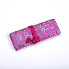 "Provide an easy way to organize your jewelry items for travel or at home. 2 zippered pockets and 1 large open pocket, one ring holder. Tie with drawstrings. Approx. 8\"L x 3\" W x 1\" when tied or 11.5\" L x 8\" W flat." Portable Pouch Pencil Case As Gift, Pink Portable Organizer For Personal Use, Pink Portable Rectangular Organizers, Handmade Pink Cosmetic Bag For Travel, Rectangular Portable Pencil Case For Gift, Rectangular Portable Pencil Case As Gift, Portable Rectangular Pencil Case Gift, Portable Rectangular Pencil Case As Gift, Purple Rectangular Pencil Case For Travel