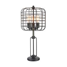 an iron cage lamp with three candles on it