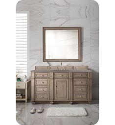 a bathroom vanity with a large mirror above it and slippers on the floor next to it