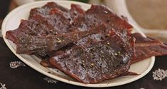 beef strips on a white plate sitting on a table