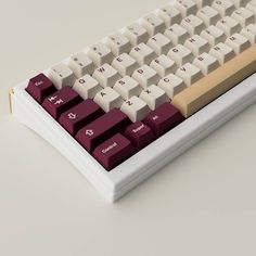 a white and red computer keyboard sitting on top of a table