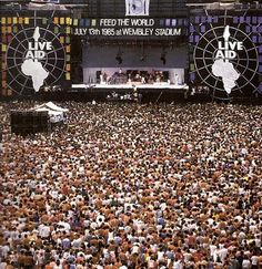 a large group of people standing on top of a stage in front of a crowd