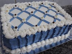 a large blue and white cake sitting on top of a counter