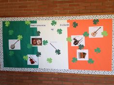 a bulletin board with shamrocks and pictures on it