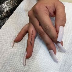 a woman's hand with a small tattoo on it