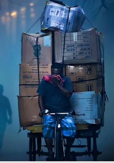 a man is sitting on a bike with boxes