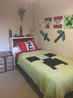 a room with a bed, dresser and other items on the wall above it is a minecraft themed bedroom