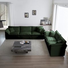 a living room filled with green couches on top of a hard wood floor