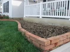 the front yard is neatly mowed and ready to be used as a flower bed