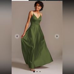 a woman in a long green dress is smiling for the camera and she has her hand on her hip