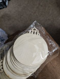 a stack of white plates sitting on top of a couch