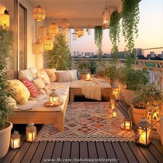 an outdoor living area with lots of plants and candles on the floor, lit by lanterns