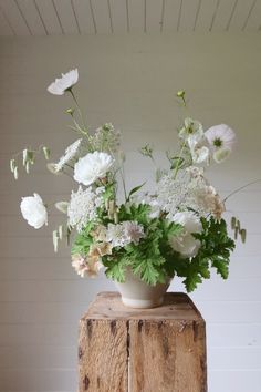 modern floral bowl with green and white floral ingredients of cosmos, roses, briza grass and pelargonium, grown in surrey upon a rustic wooden plinth. White Flower Centrepiece, Green And White Floral Arrangements, Wedding Sustainable, Aesthetic Season, Flowers Cosmos, White Flower Centerpieces, Floral Centrepiece, Event Studio, White Floral Arrangements