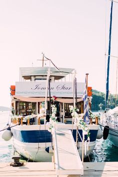 the boat is docked at the dock by the water