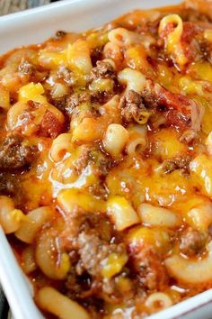 a white casserole dish filled with macaroni, cheese and ground beef