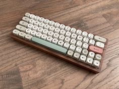 an old computer keyboard sitting on top of a wooden table next to a mouse pad