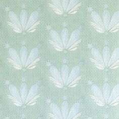 a blue and white flower pattern on a light green background with small dots in the middle