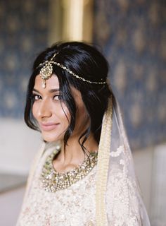 a woman in a wedding dress with a veil on her head