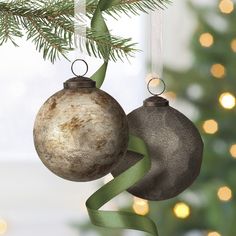 two ornaments hanging from a christmas tree