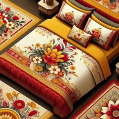 a bed covered in yellow and red comforters with flowers on the bedspread