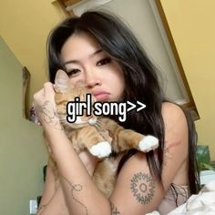 a woman holding a cat in her arms with the caption girl song on it