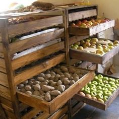 an assortment of different types of doughnuts and pastries on display in wooden crates