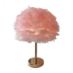 a lamp that is on top of a stand with a pink light in the shape of an ostrich