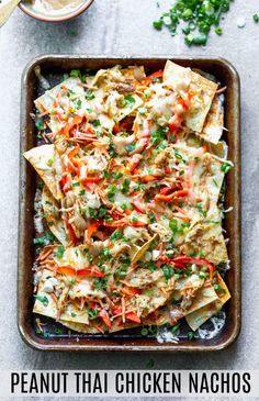 nachos with shredded carrots and parsley on top