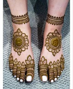 the feet are decorated with henna designs