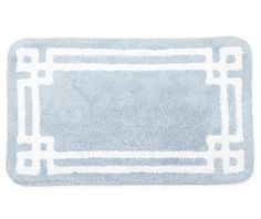 a blue and white bath mat with an interlocked design on the front side