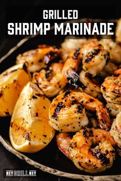 grilled shrimp marinade in a skillet with lemon wedges