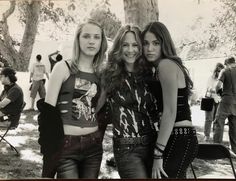 three young women standing next to each other