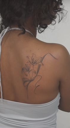 a woman with a flower tattoo on her back